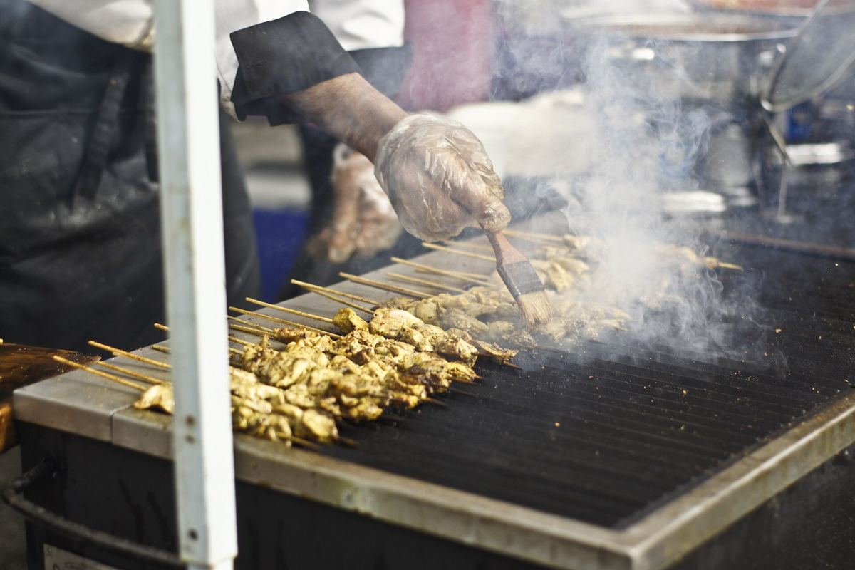 Chicken skewers cooking on a hot grill