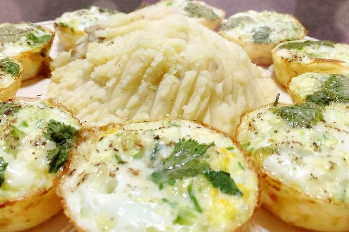 Baked egg muffins topped with fresh herbs and black pepper, served on a plate